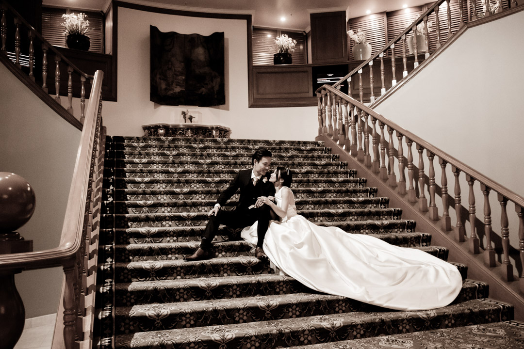 Wedding couple sits on the hotel stairs at Brisbane's Stamford Plaza.