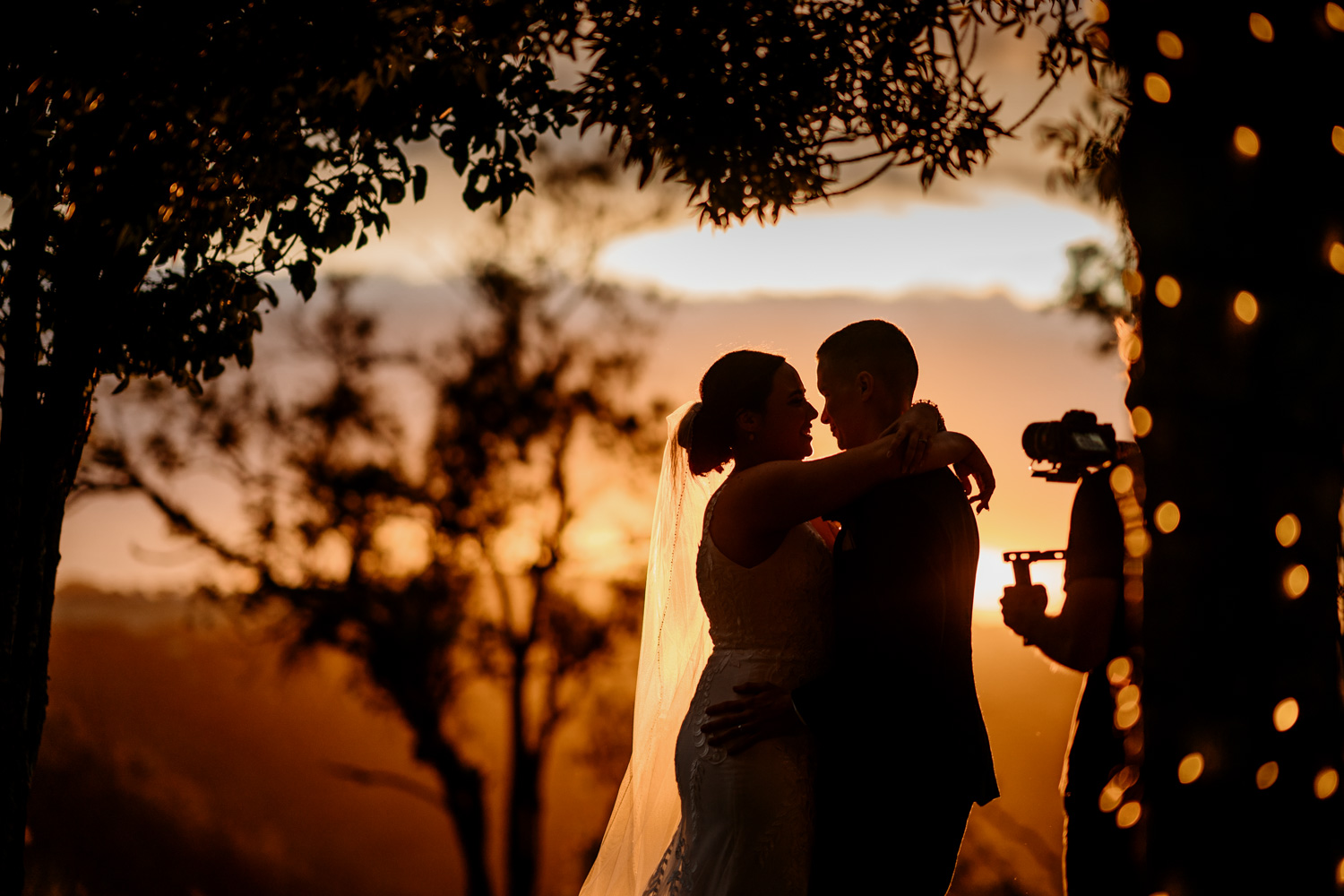 wedding videographer recording at sunset